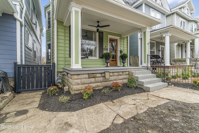 doorway to property featuring covered porch and ceiling fan