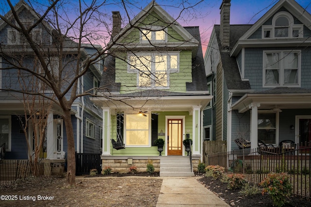 view of front of home with a fenced front yard and a chimney