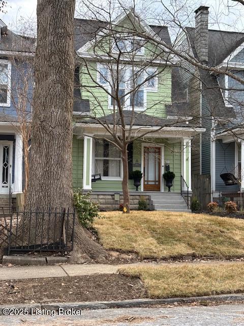 view of front facade featuring a chimney and a front lawn