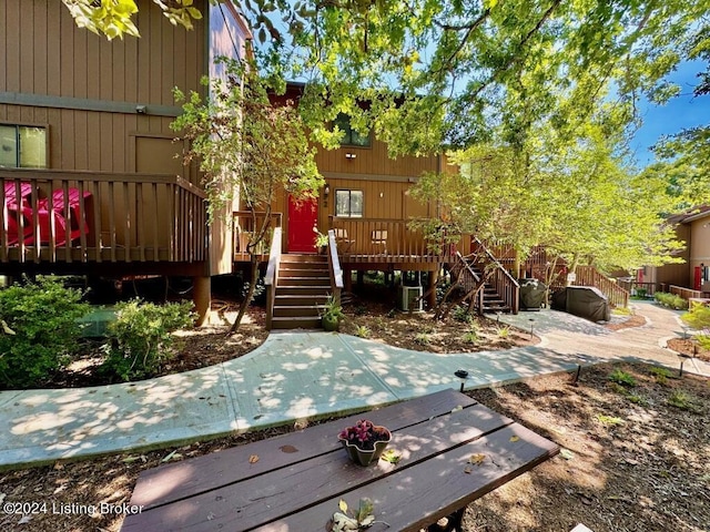 exterior space with stairs and a deck