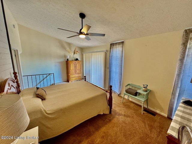 bedroom featuring a ceiling fan, carpet flooring, a textured ceiling, and baseboards