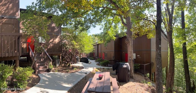 view of home's community with a deck and stairway