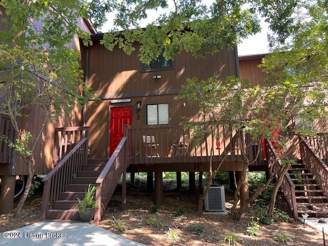 view of jungle gym with stairway, a deck, and central AC