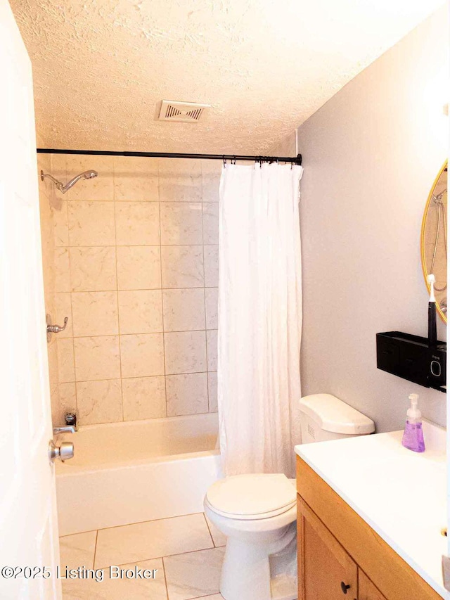 full bath featuring toilet, shower / bath combo with shower curtain, a textured ceiling, vanity, and tile patterned floors