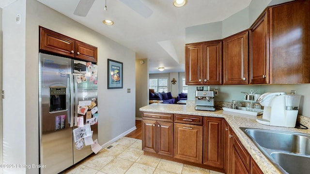 kitchen featuring light tile patterned flooring, recessed lighting, a sink, baseboards, and stainless steel refrigerator with ice dispenser