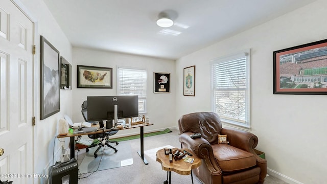 carpeted home office featuring baseboards