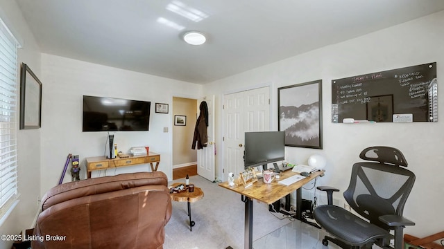 office area featuring arched walkways and baseboards