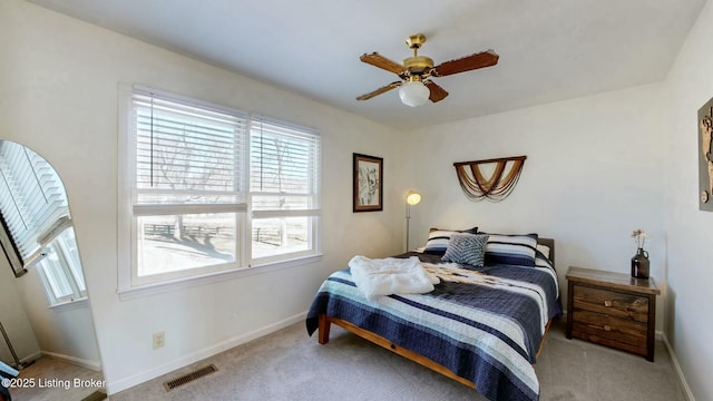 bedroom with carpet floors, baseboards, multiple windows, and visible vents