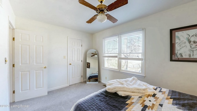 bedroom featuring a ceiling fan, carpet, and baseboards