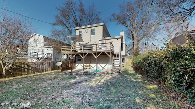 back of house with a yard, a chimney, fence, a deck, and stairs