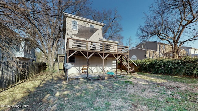 rear view of property with fence, stairway, and a wooden deck