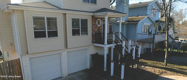 view of front of home with an attached garage and fence