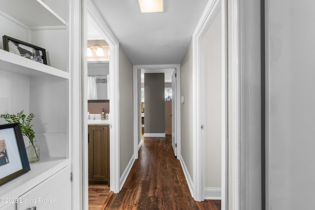 hall with baseboards and dark wood finished floors