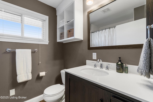 full bath with baseboards, visible vents, vanity, and toilet