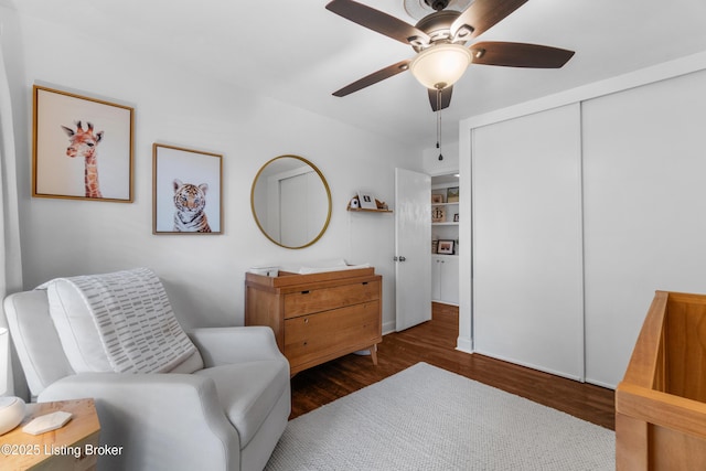 sitting room featuring ceiling fan and dark wood finished floors