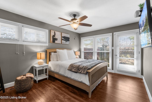 bedroom featuring ceiling fan, access to outside, dark wood-style flooring, and baseboards