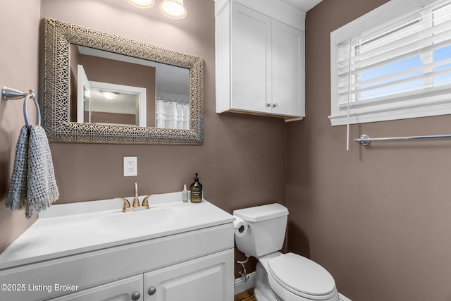 bathroom featuring vanity and toilet