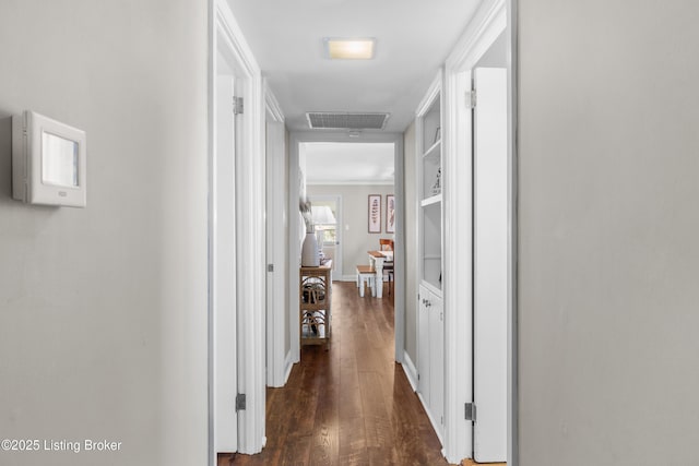 hall featuring ornamental molding, dark wood finished floors, and visible vents