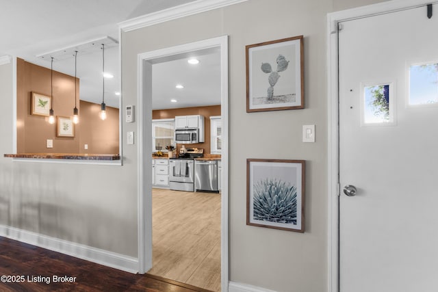 corridor with recessed lighting, baseboards, and wood finished floors