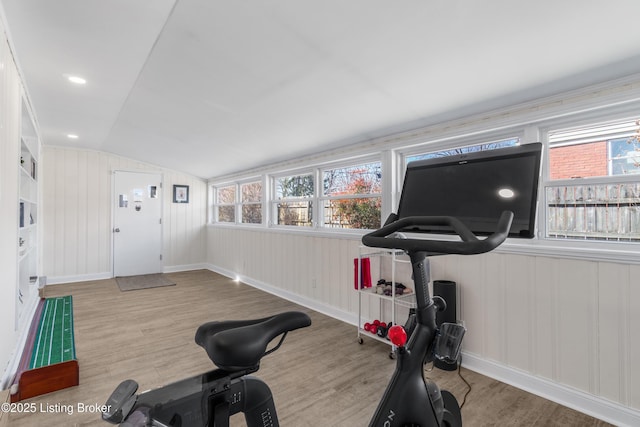 exercise room featuring lofted ceiling, baseboards, recessed lighting, and wood finished floors