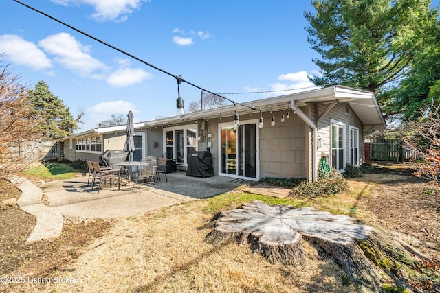 rear view of house featuring a patio area and fence