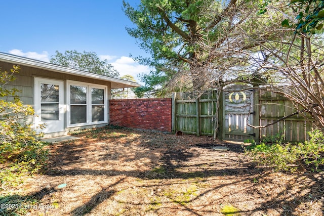 view of yard featuring a gate and fence