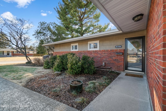 property entrance featuring brick siding