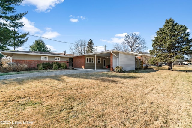 ranch-style home featuring a carport, brick siding, and a front yard