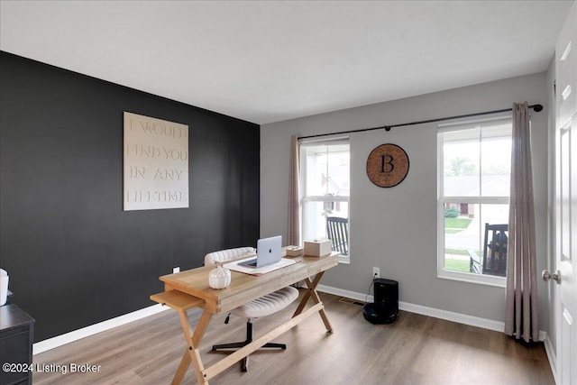 home office featuring wood finished floors, visible vents, and baseboards