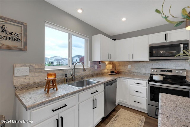 kitchen featuring appliances with stainless steel finishes, a sink, and tasteful backsplash