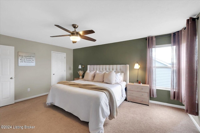 bedroom with baseboards, a ceiling fan, and light colored carpet