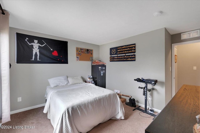 bedroom with carpet floors, visible vents, and baseboards