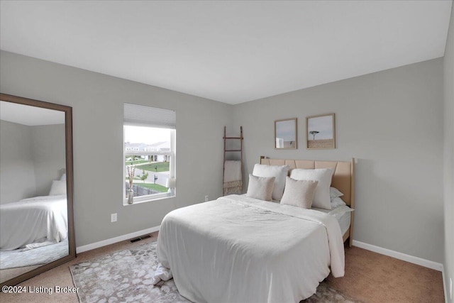 bedroom with carpet, visible vents, and baseboards