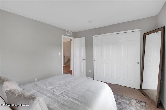 bedroom featuring carpet floors, a closet, and visible vents