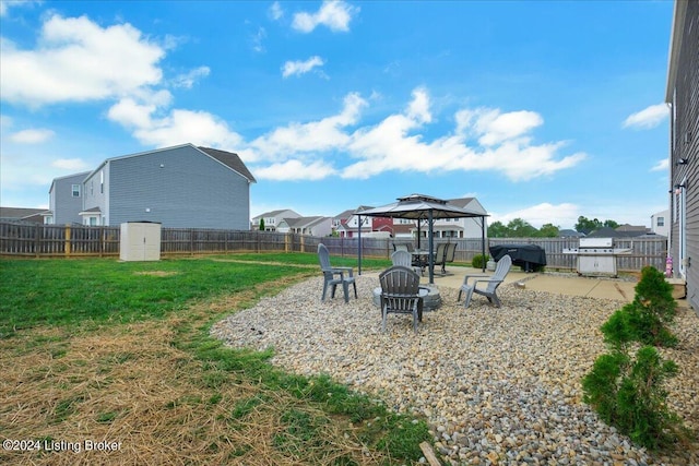 view of yard with a fire pit, a gazebo, a patio, and a fenced backyard