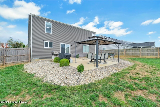 back of property featuring a gazebo, a fenced backyard, a lawn, and a patio