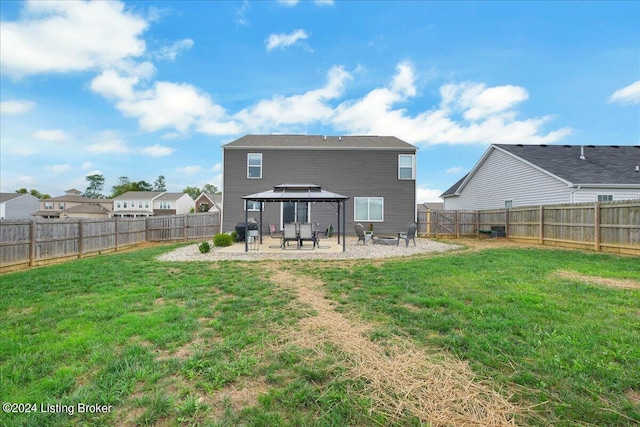 rear view of house with a patio area, a gazebo, a fenced backyard, and a yard