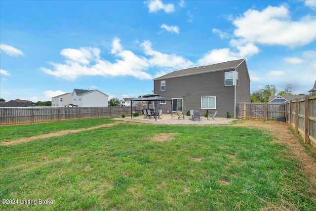 back of house featuring a patio area, a fenced backyard, a lawn, and a gazebo