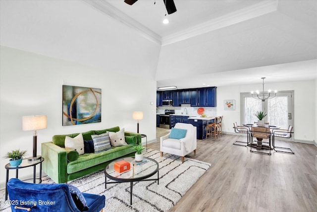 living area featuring light wood-type flooring, crown molding, baseboards, and ceiling fan with notable chandelier