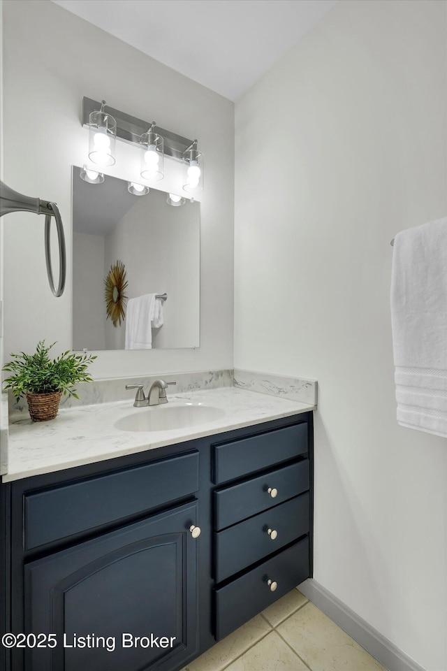 bathroom featuring tile patterned flooring, baseboards, and vanity