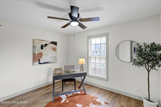 office area with ceiling fan, baseboards, and wood finished floors