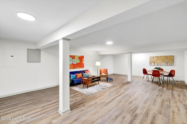 interior space with light wood-style floors, electric panel, and baseboards