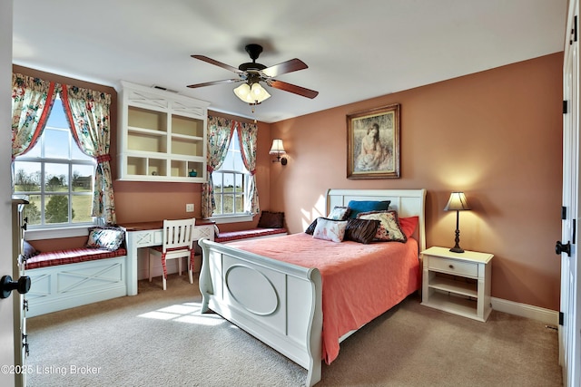 carpeted bedroom featuring baseboards, visible vents, and a ceiling fan