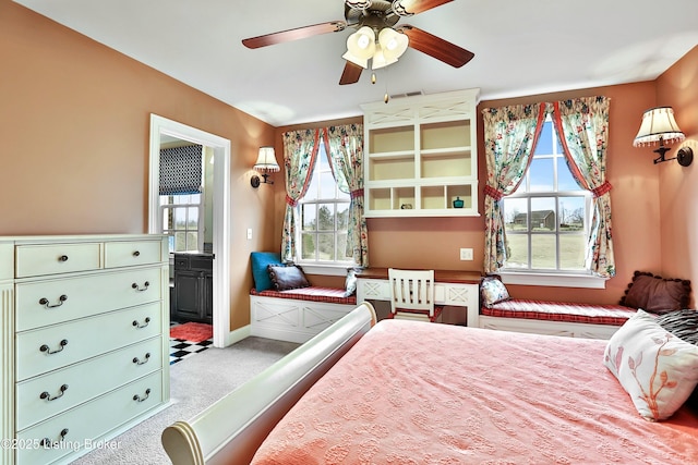 bedroom with carpet floors, visible vents, baseboards, and connected bathroom