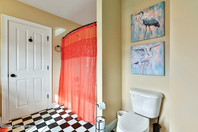 full bathroom with toilet and tile patterned floors