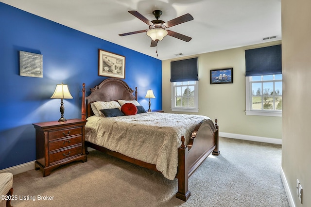 bedroom with carpet floors, a ceiling fan, visible vents, and baseboards