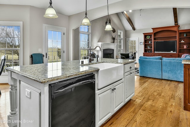 kitchen with vaulted ceiling with beams, dishwasher, light wood-style flooring, and a sink