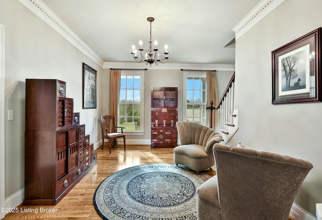 living area featuring stairway, light wood-style floors, ornamental molding, a chandelier, and baseboards