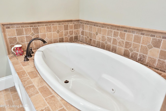 bathroom featuring a tub with jets