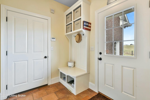 mudroom featuring tile patterned flooring and baseboards